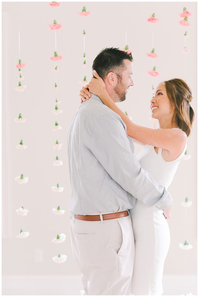 couple in front of floating floral wall