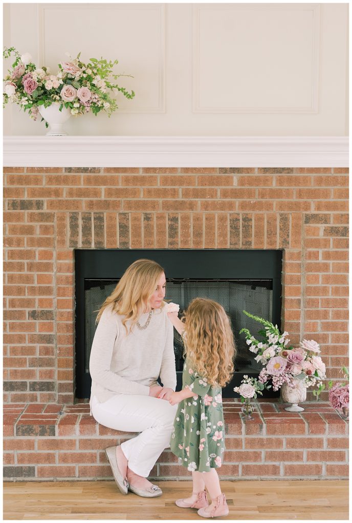 daughter handing flower to mother