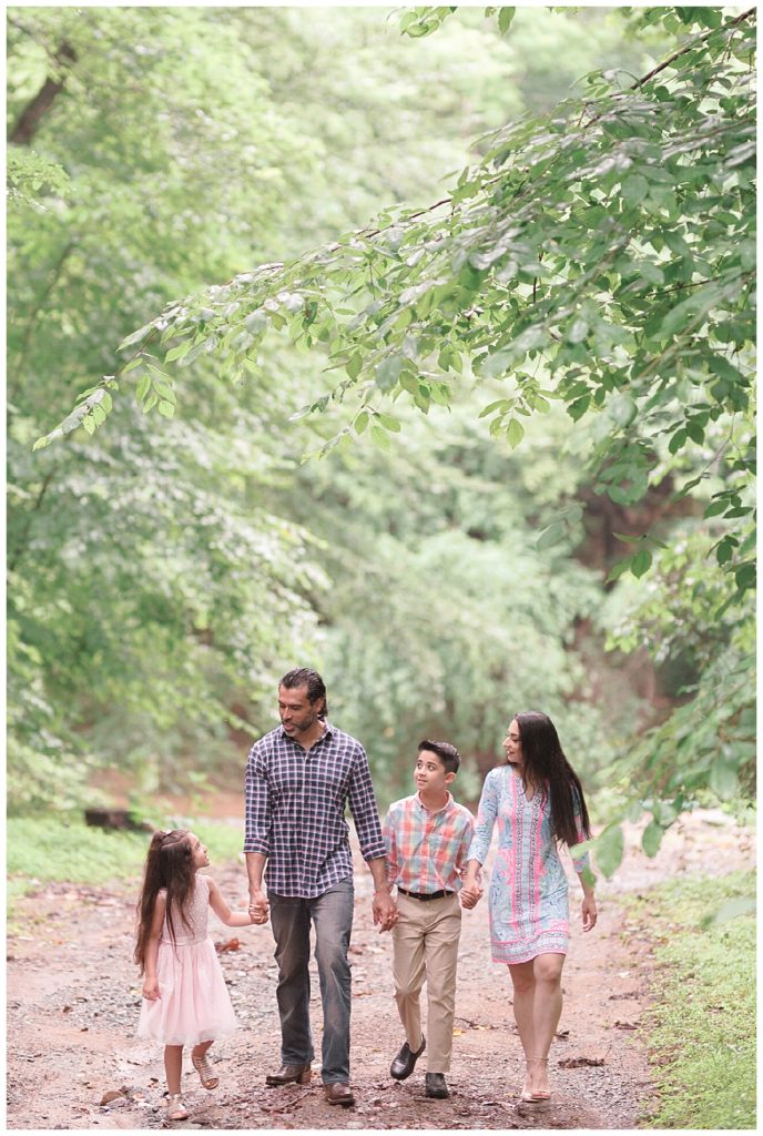 family walking through woods together