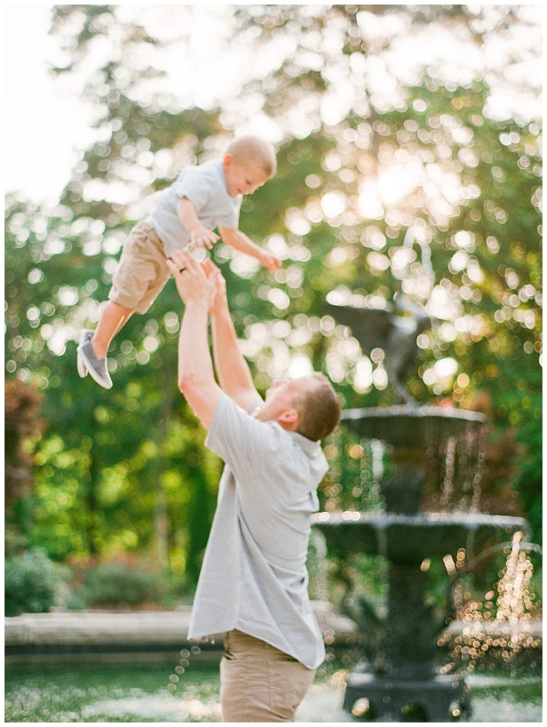 dad throwing son into the air
