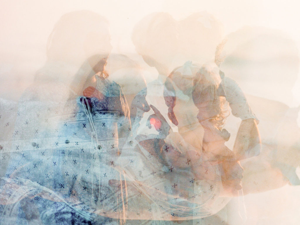 double exposure of family on film at sunrise on the beach