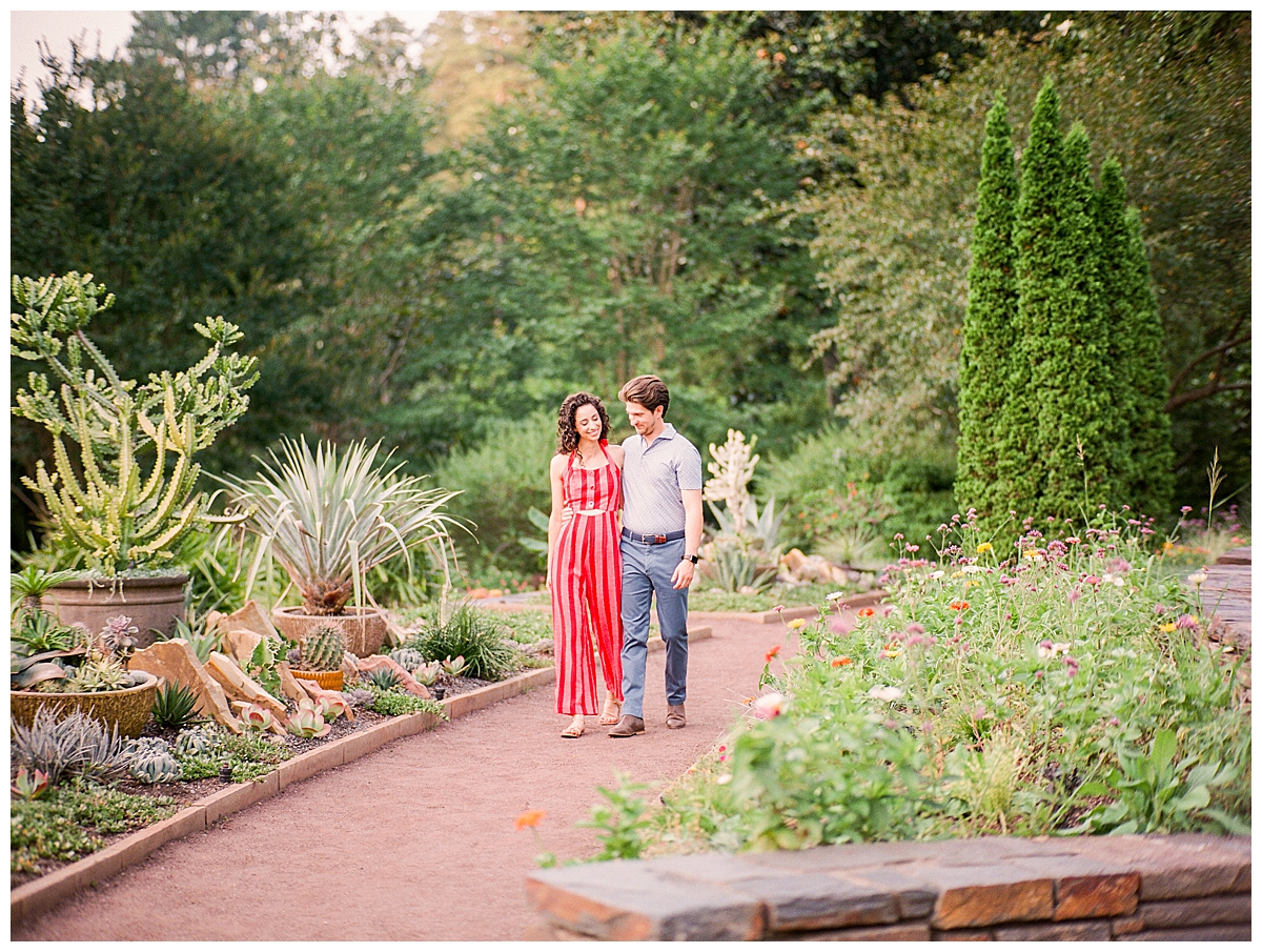 engaged couple walking in duke gardens