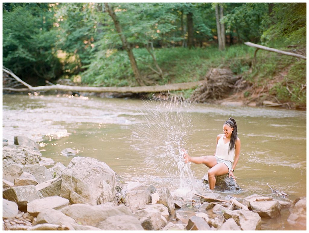 woman splashing water at eno river