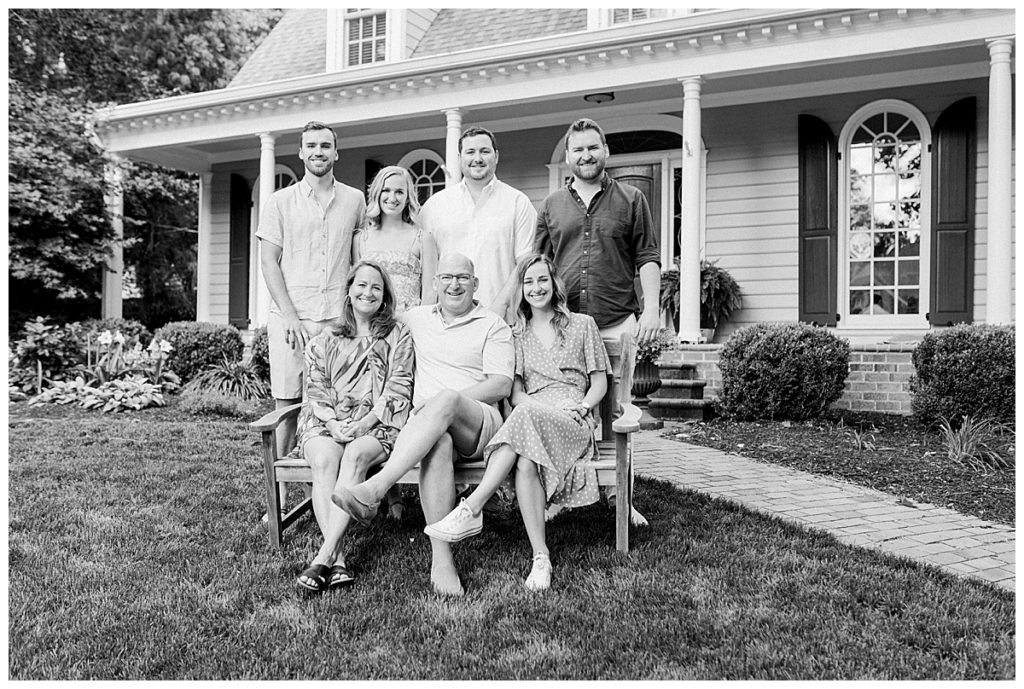 black and white family photo outside of house