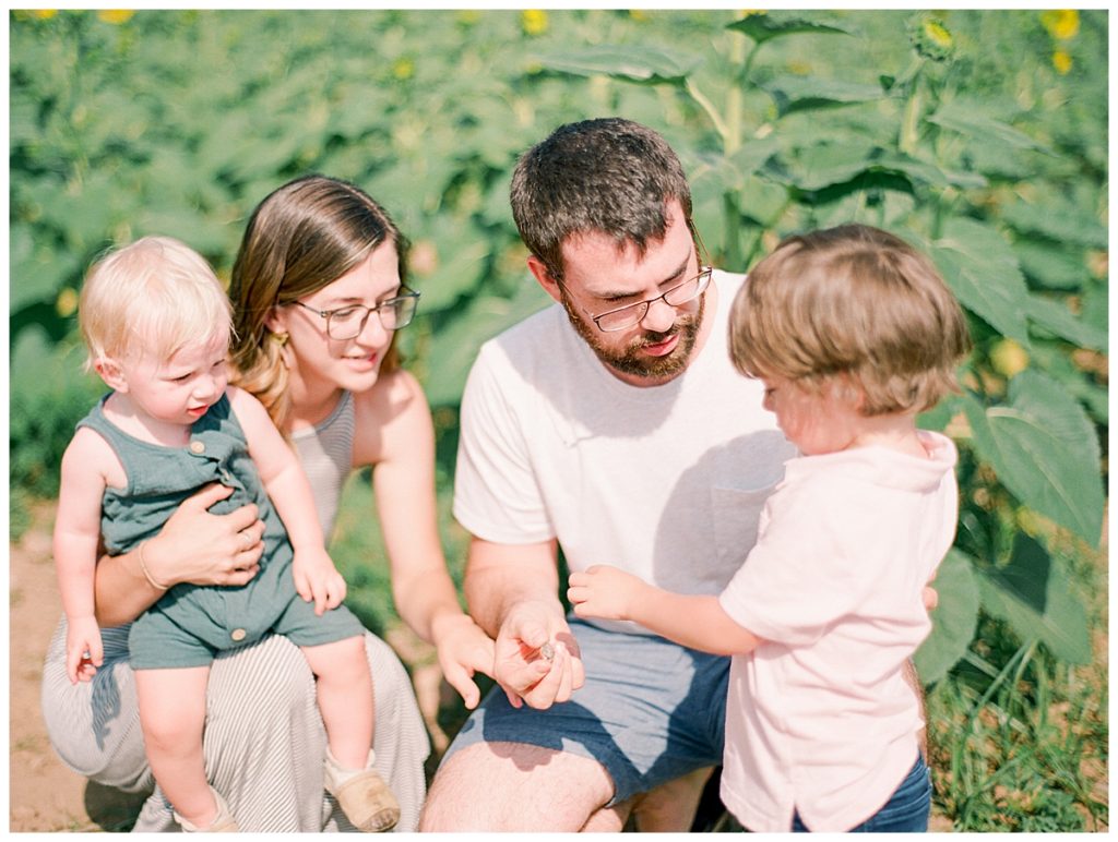 parents with kids in a sunflower field
