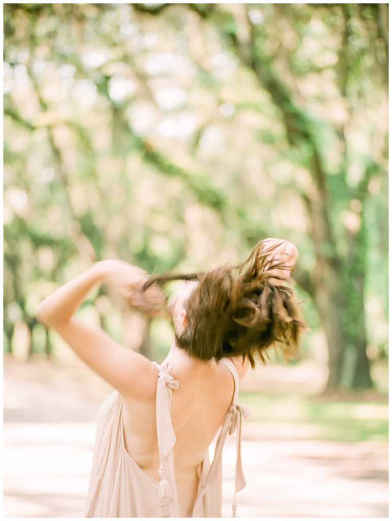 woman flipping over hair at wormsloe 