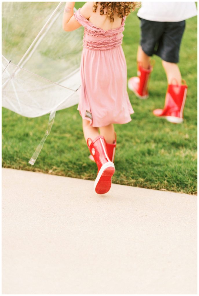 children running with red rainboots