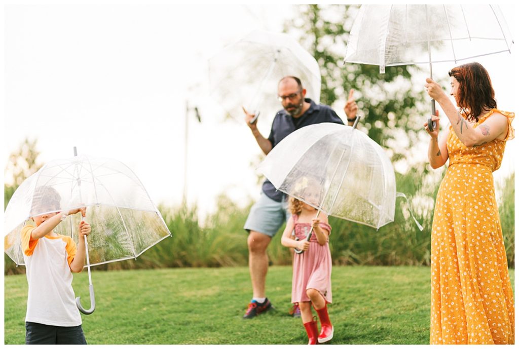 family playing with clear umbrellas