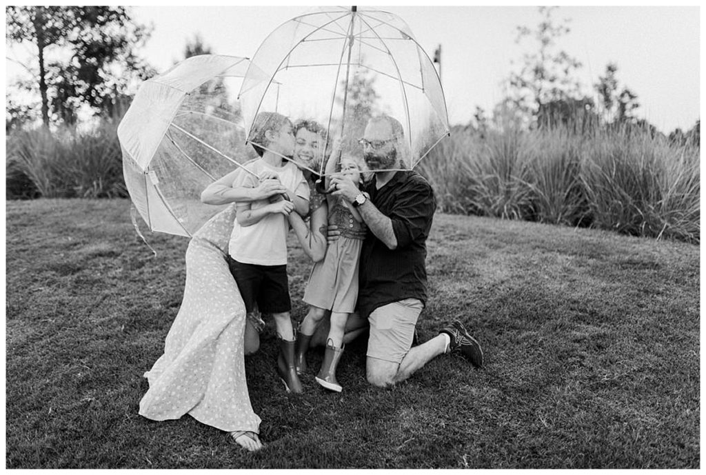 family playing with clear umbrellas