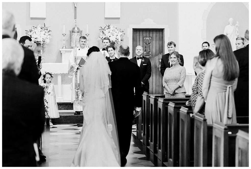 bride and groom walking down aisle at sacred heart cathedral raleigh