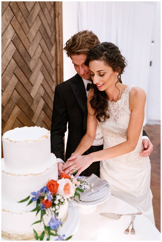 bride and groom cutting cake