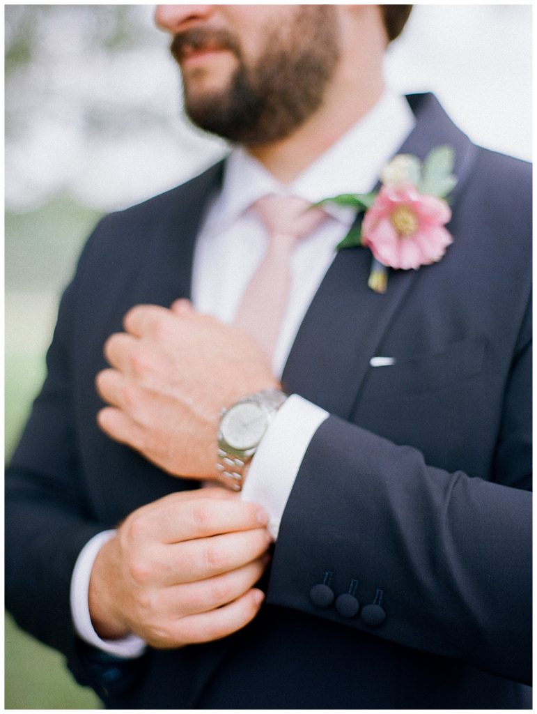 groom adjusting watch