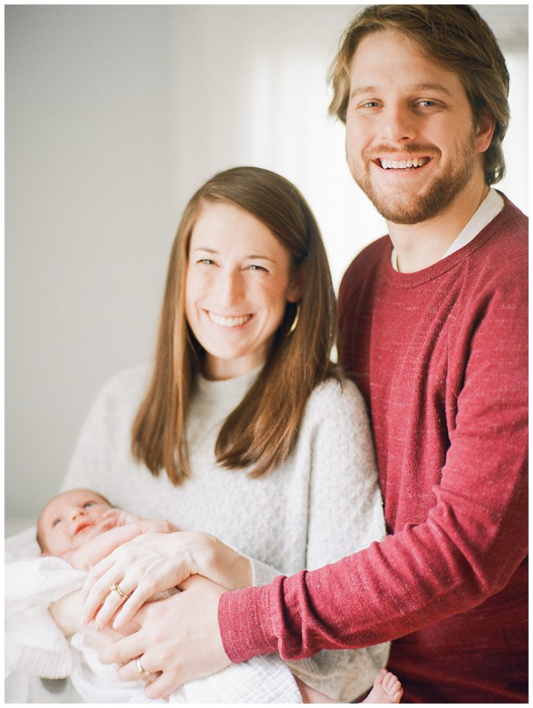 mom and dad with newborn on film