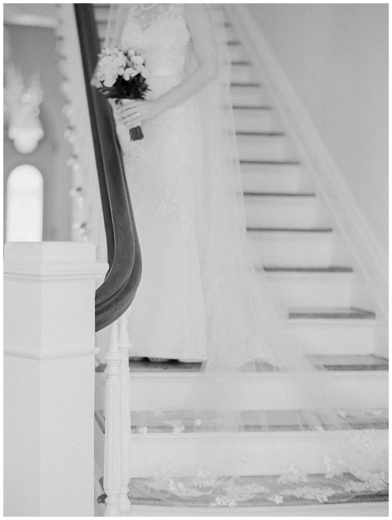 black and white bride on stairs with cathedral veil