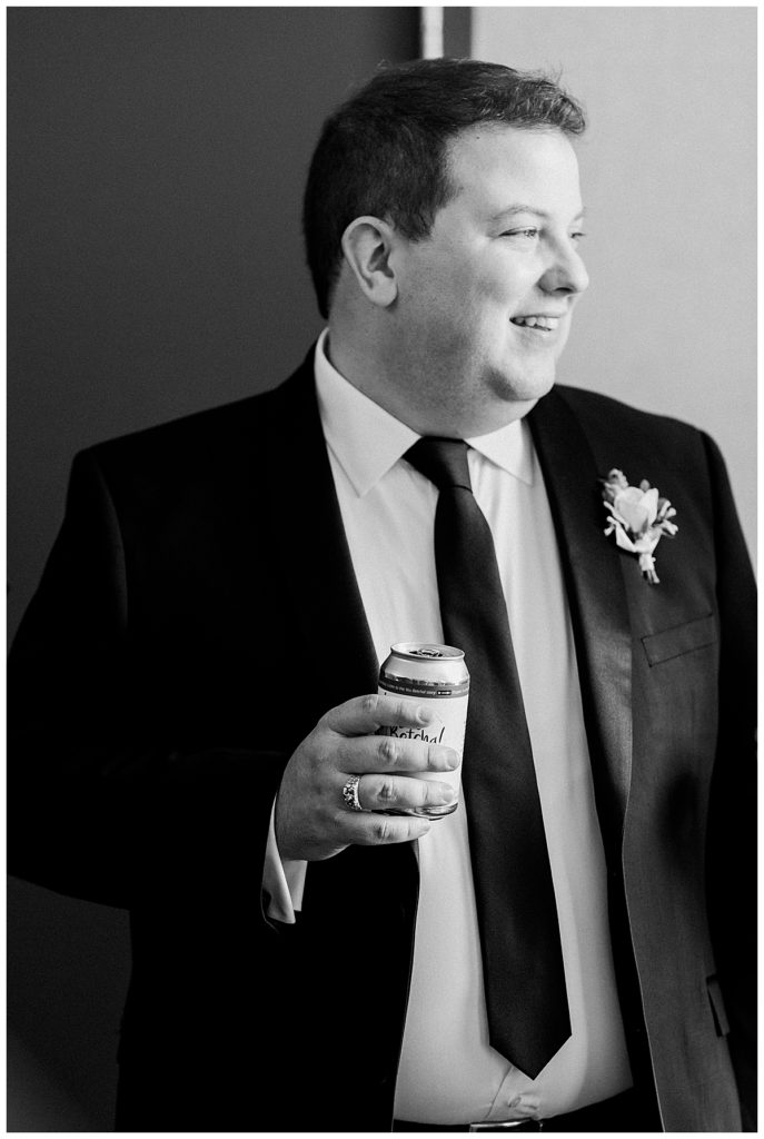 groom in black and white getting ready for wedding day