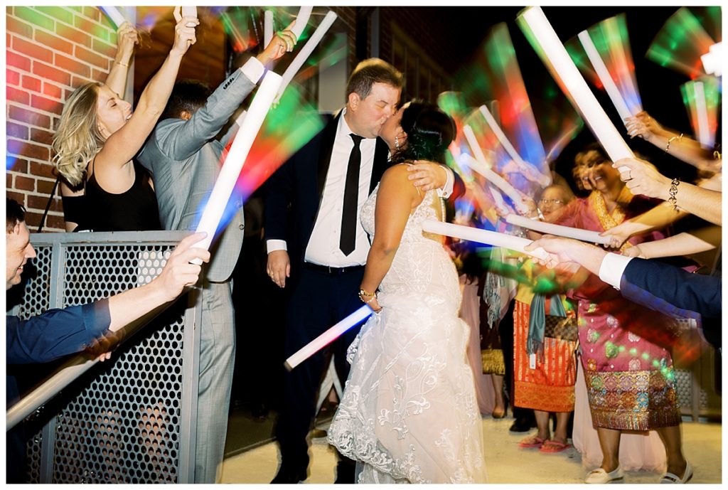 bride and groom exit with glow sticks