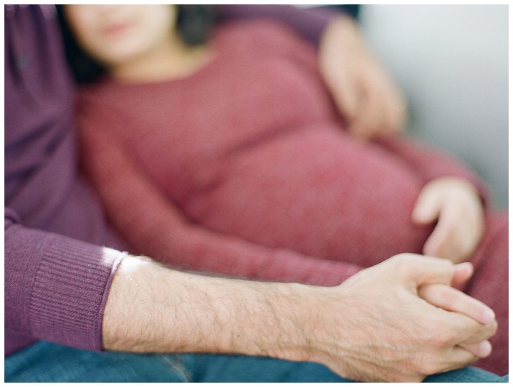 maternity couple on couch