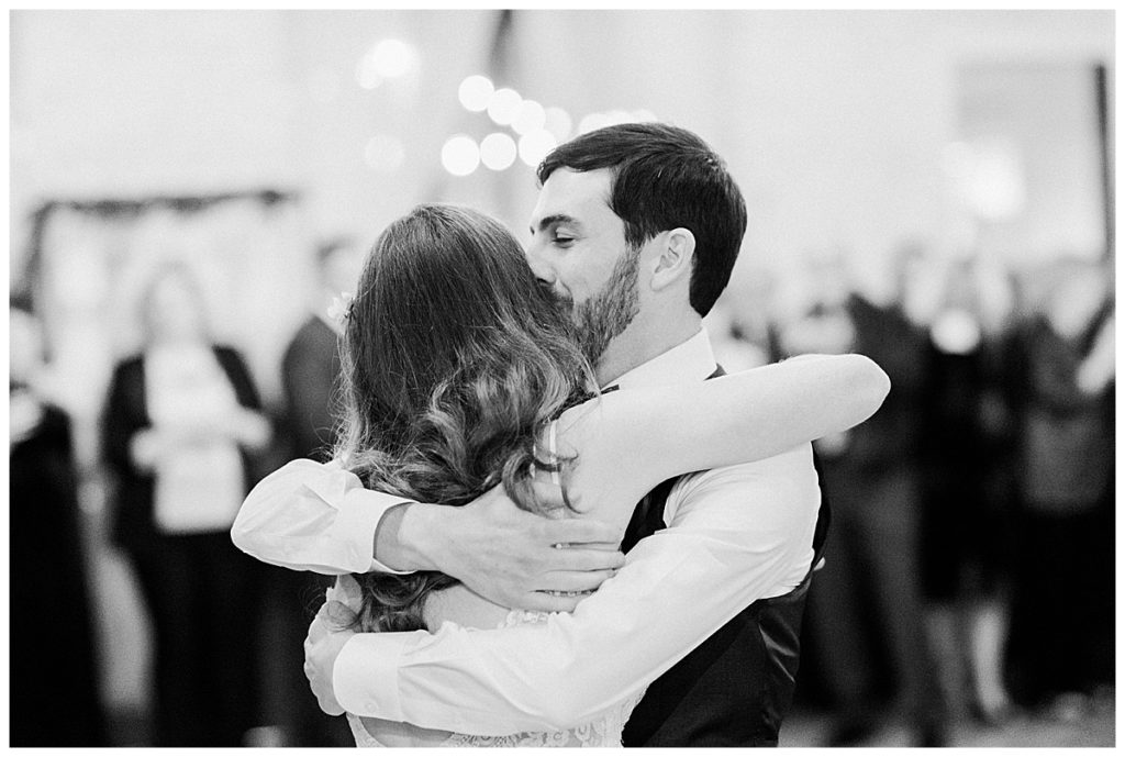 bride and groom hug at wedding reception