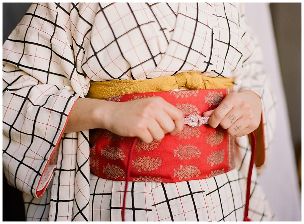 woman getting dressed in kimono