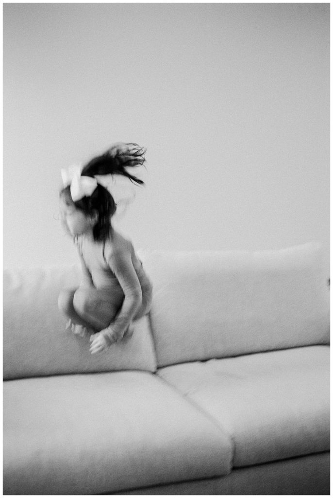 girl jumping on couch
