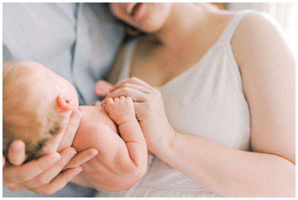 mom and dad holding newborn baby