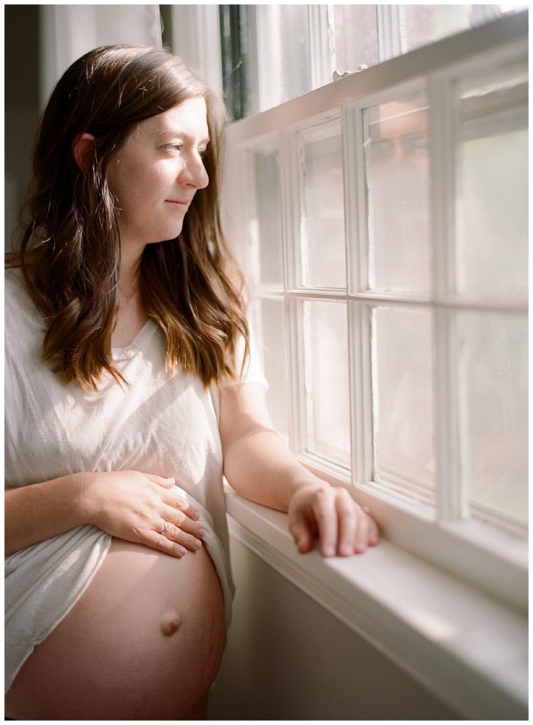 pregnant woman looking out of window