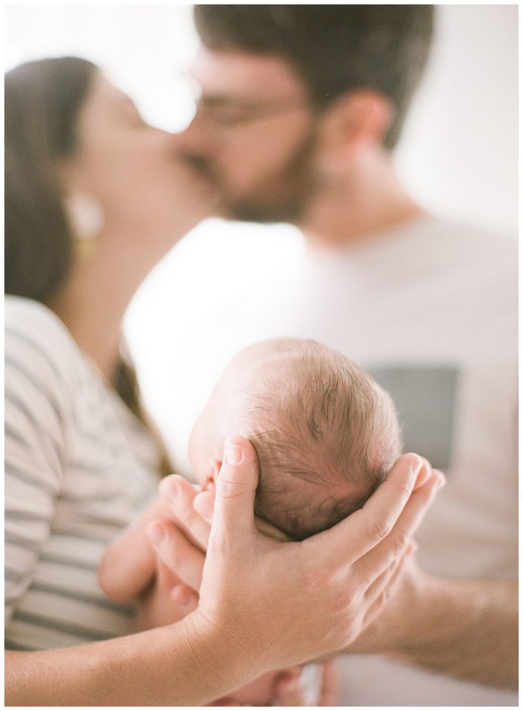 Mom and Dad holding newborn baby