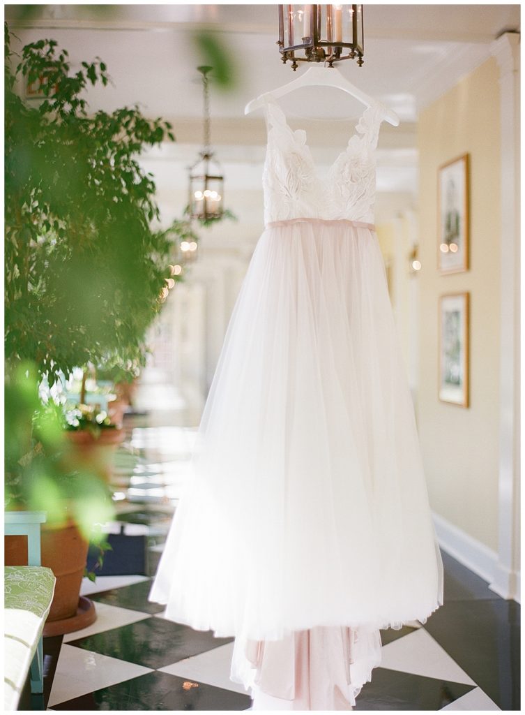 Bride's Dress Hanging in Black and White Hallway | The Carolina Inn