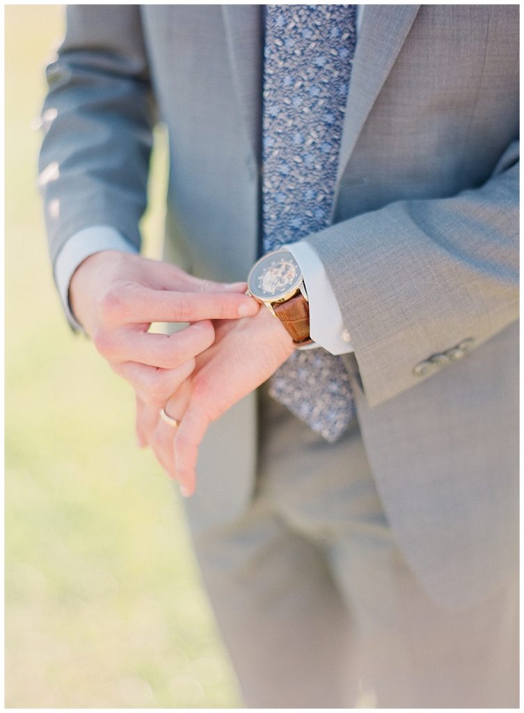 Groom adjusts watch at the NC Museum of Art