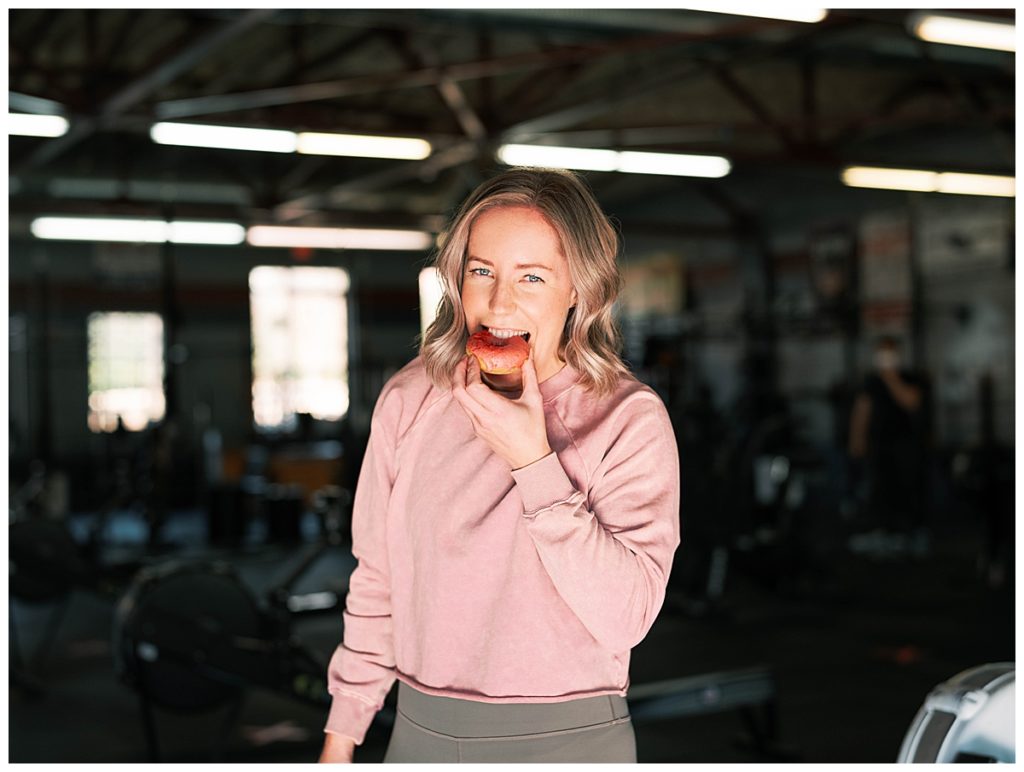 Nutrition coach eating donut at crossfit gym