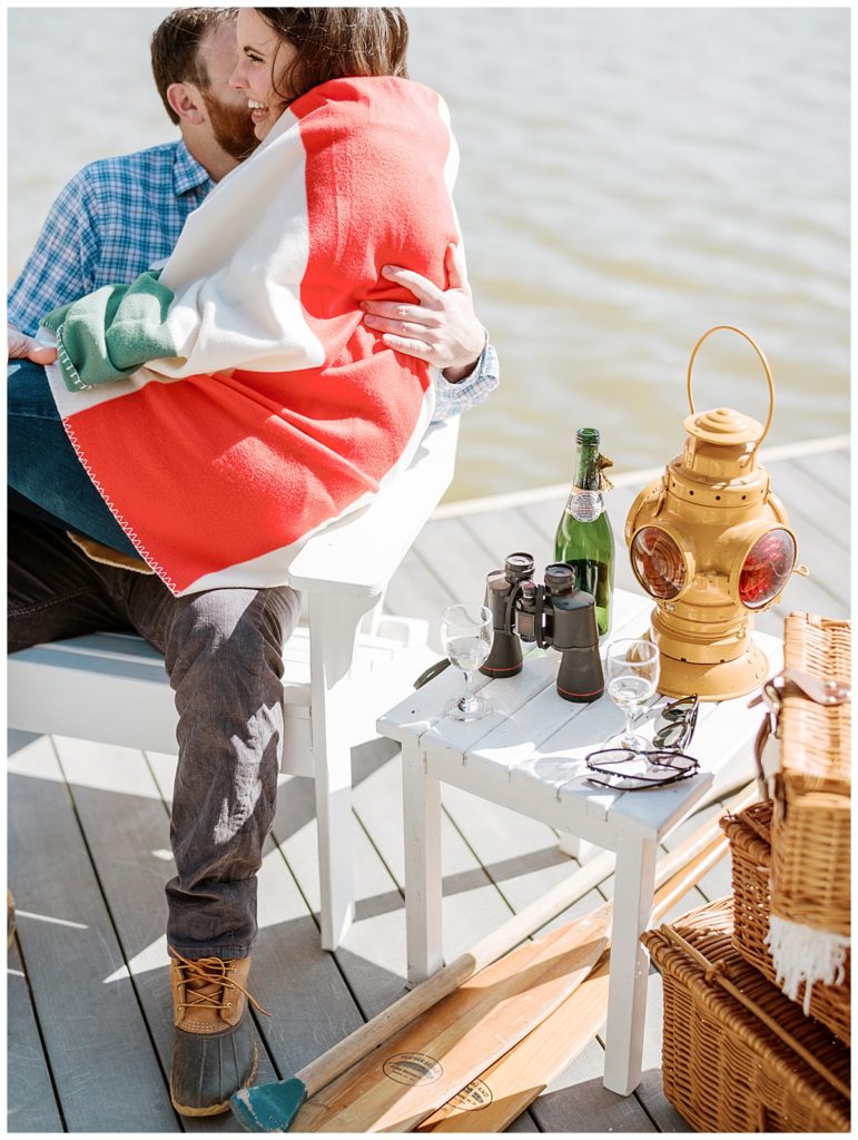 couple cuddling on a dock