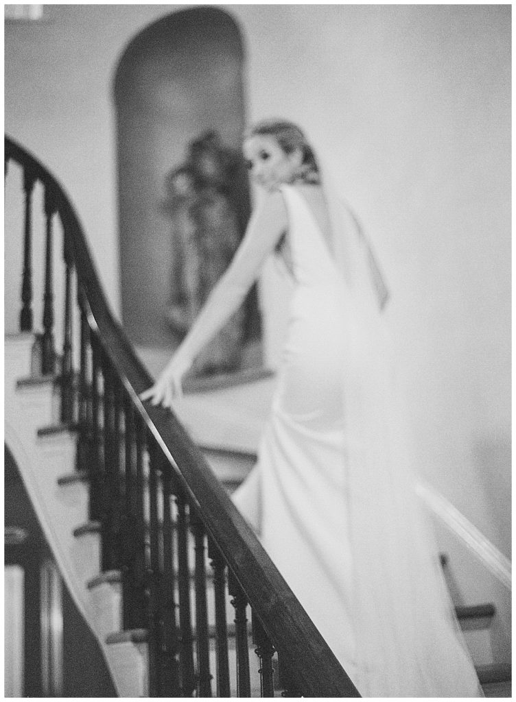 Bride ascending stairs at Heights House NC