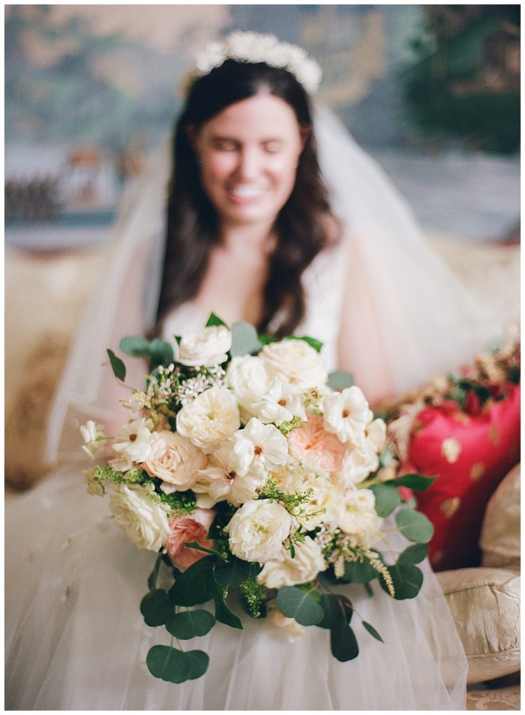 bride with white floral bouquet