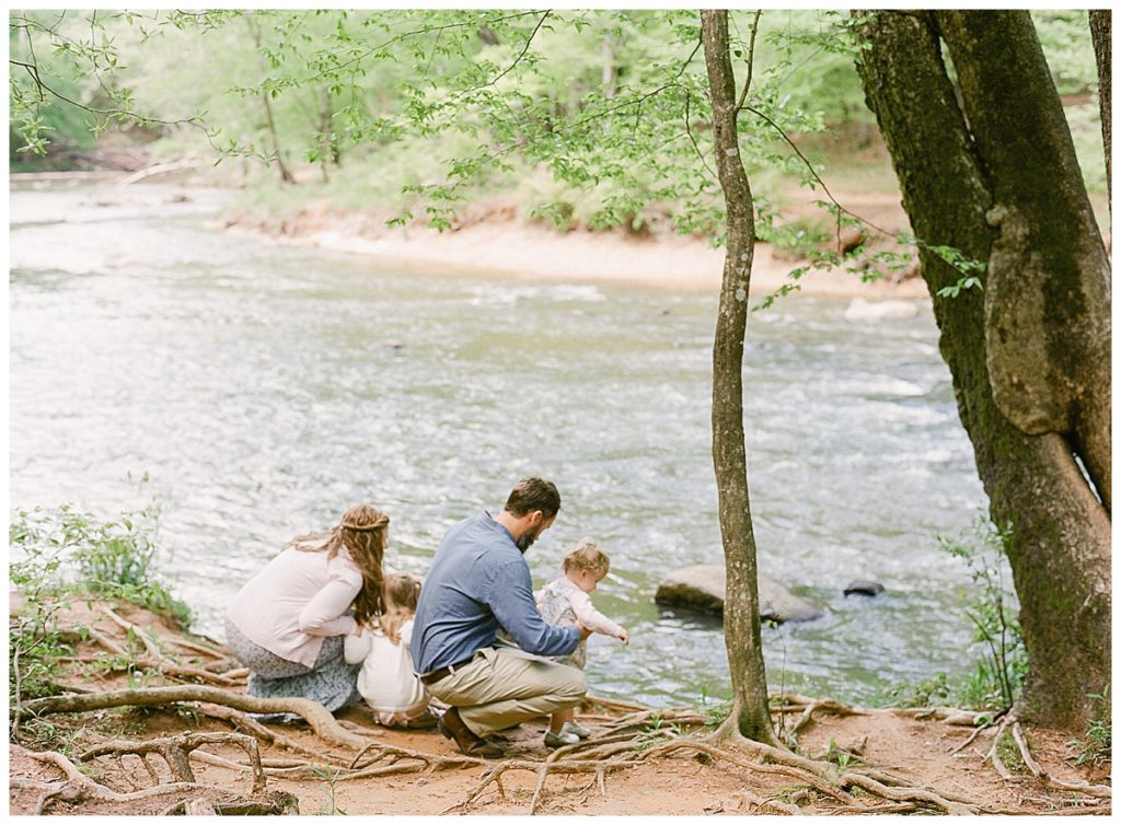 family on banks of eno river