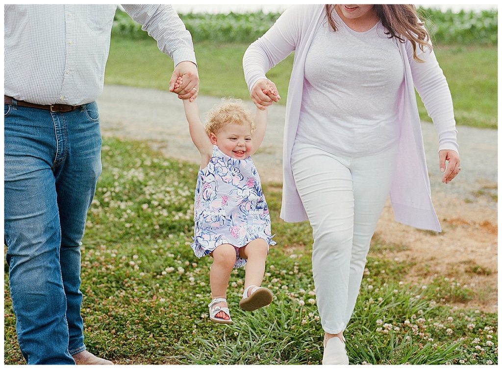 parents swinging daughter