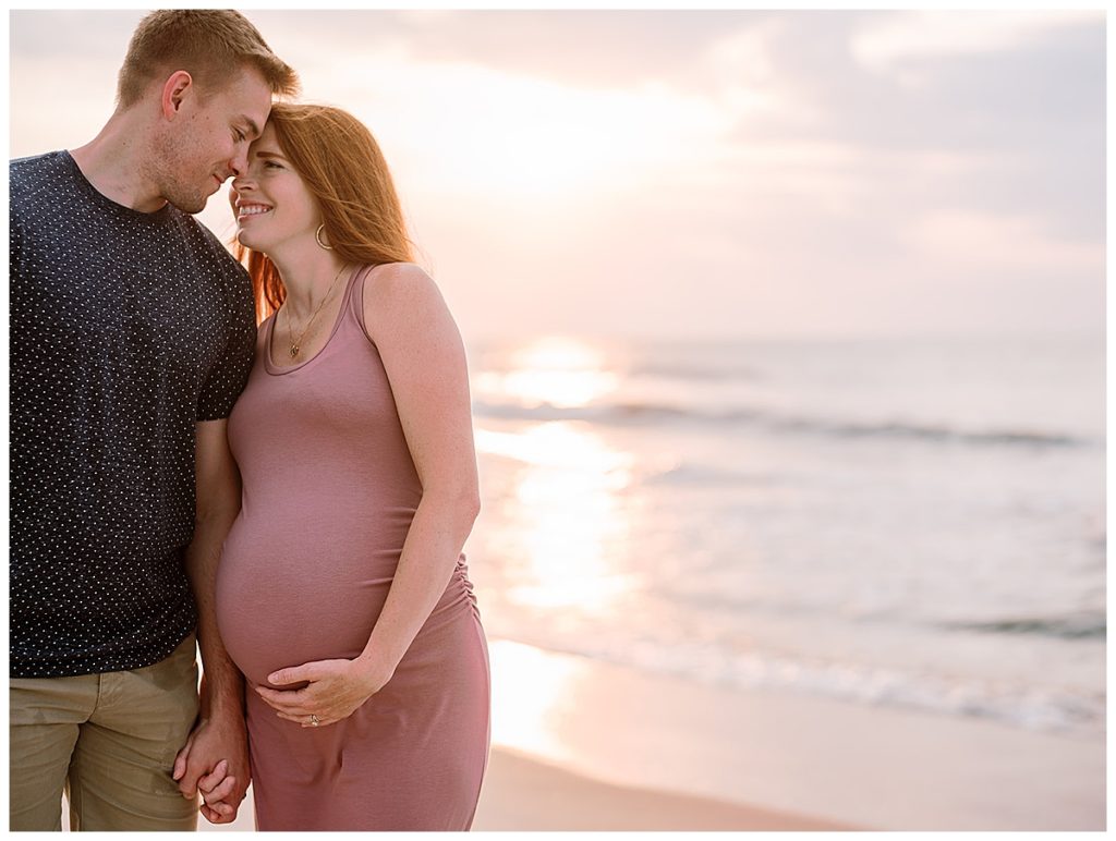 Maternity photo of couple at the beach