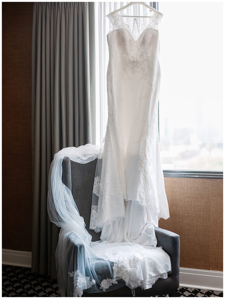 Bride's wedding dress hanging in her room