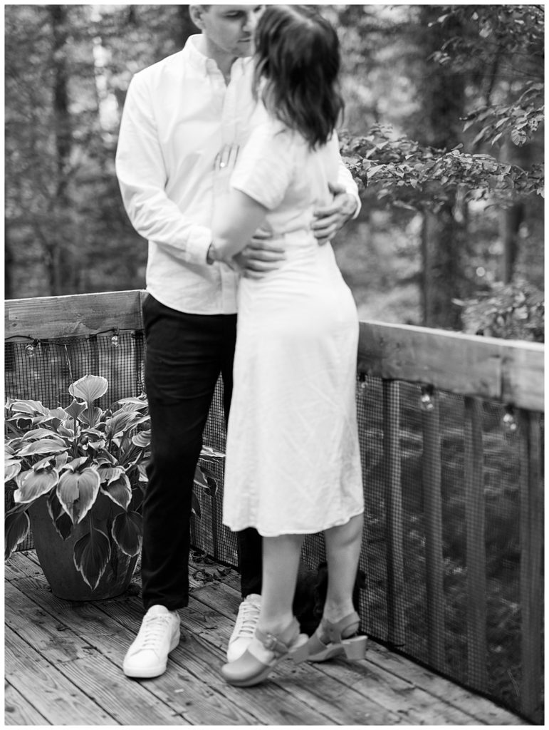 black and white photo of couple hugging on deck