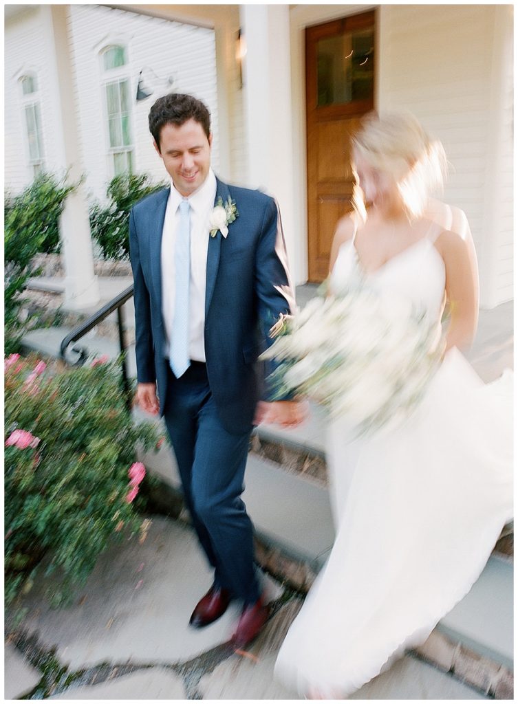 blurry image of bride and groom walking together