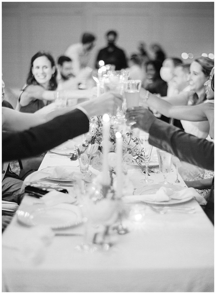 clinking glasses at wedding reception