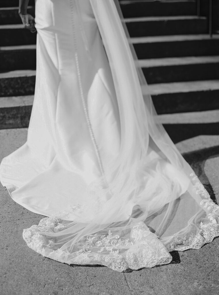 bride's train as she enters the church; black and white image taken on film