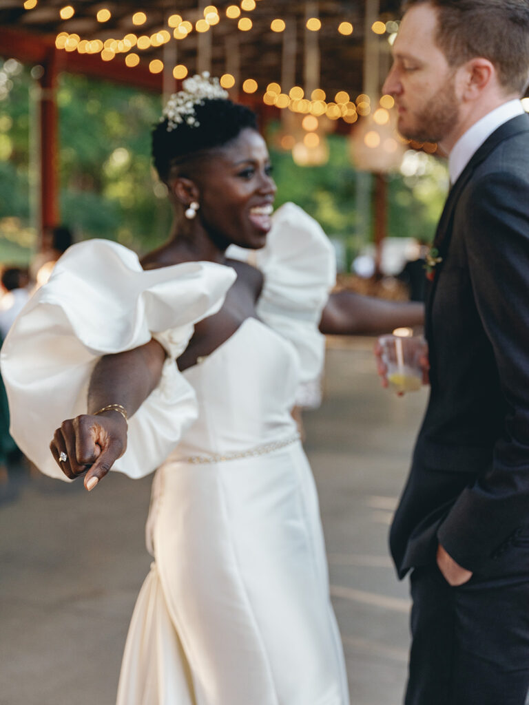 bride and groom during reception sharing a fun, private moment